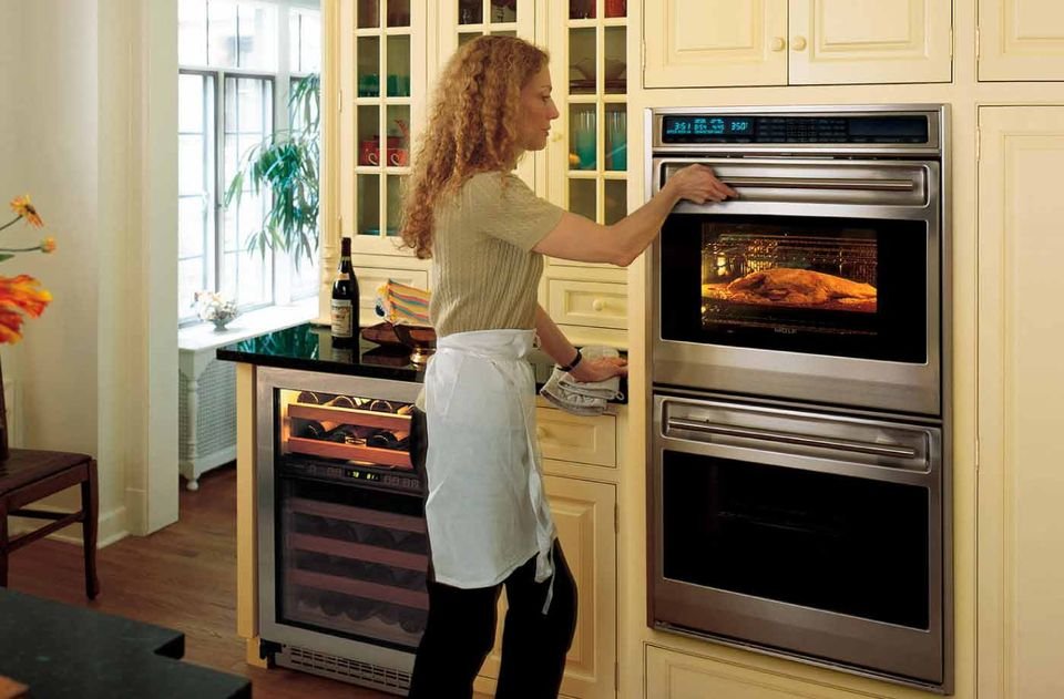 Lady using a built-in oven
