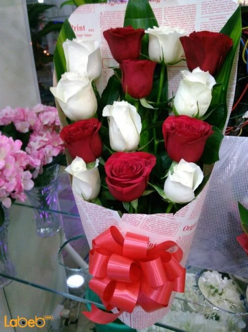 Natural Roses bouquet - white and red - green leaves in background